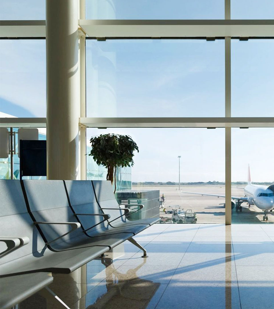 Airport terminal, people going to airplane in background